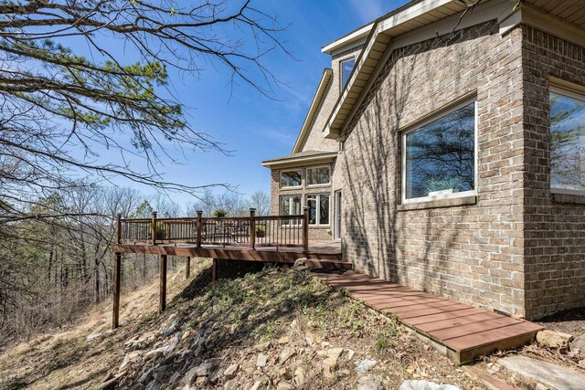 view of property exterior featuring a wooden deck
