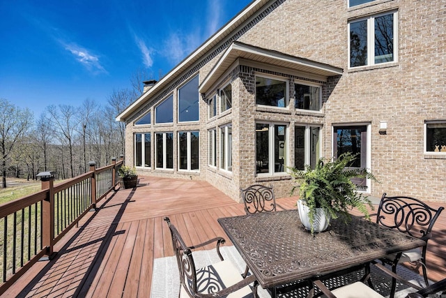 wooden deck featuring outdoor dining area