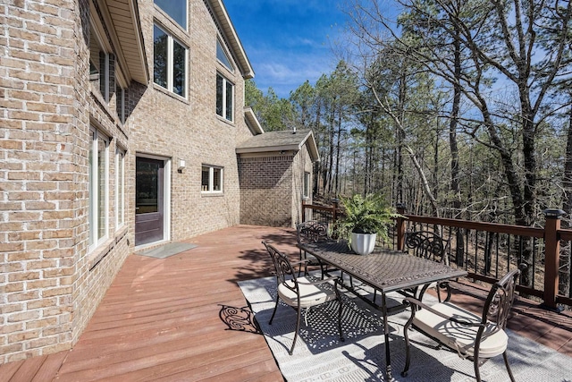 wooden deck featuring outdoor dining space