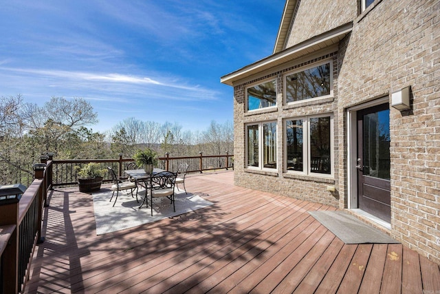 wooden deck featuring outdoor dining space