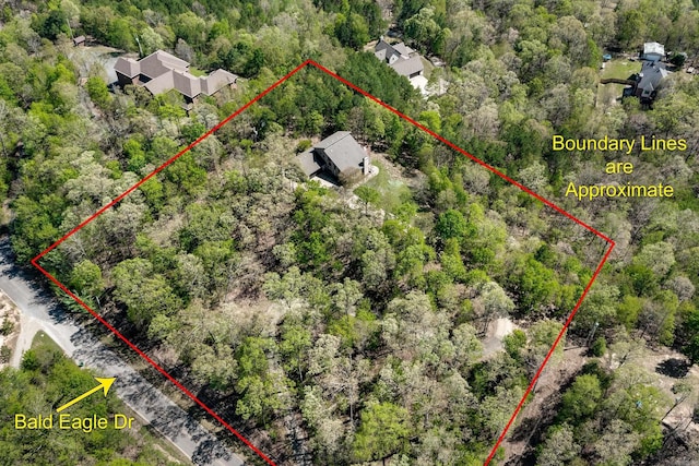 birds eye view of property featuring a wooded view