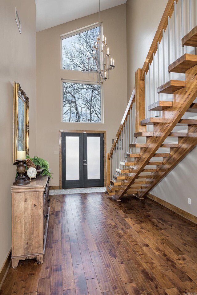 entrance foyer featuring french doors, a high ceiling, stairs, and hardwood / wood-style flooring