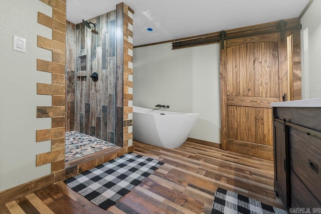 344 Rockwood Ln, Clinton, AR 72031 - bathroom featuring a soaking tub, baseboards, a tile shower, and wood finished floors