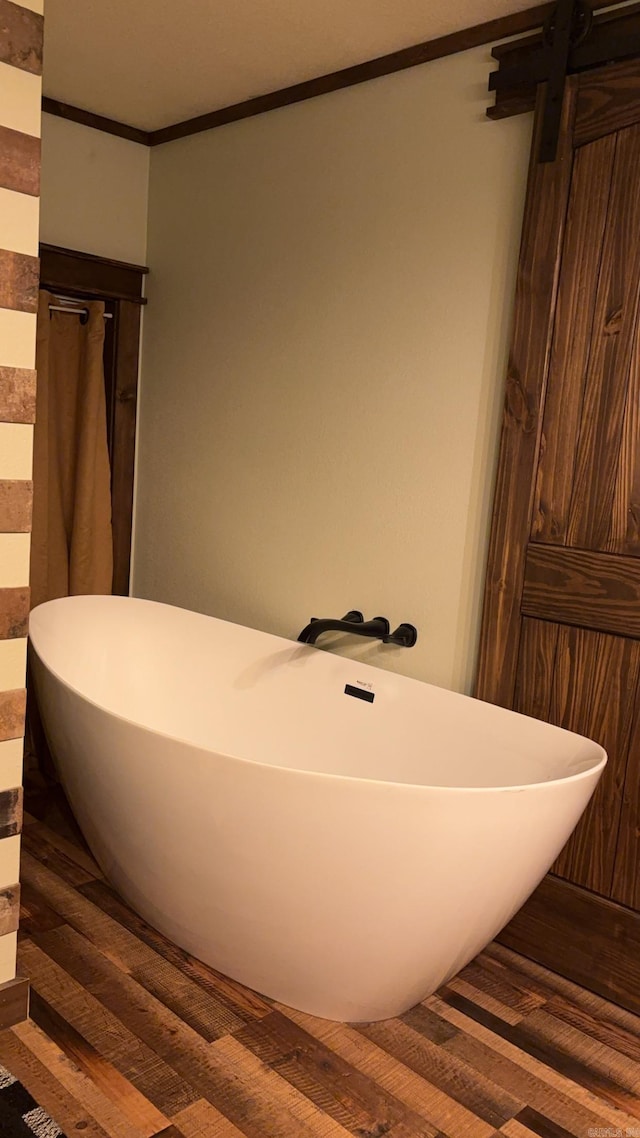 344 Rockwood Ln, Clinton, AR 72031 - full bath featuring a freestanding tub, crown molding, and wood finished floors