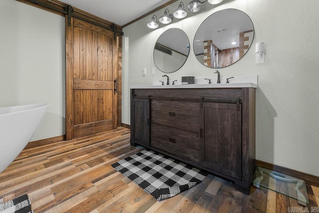344 Rockwood Ln, Clinton, AR 72031 - full bathroom with ornamental molding, baseboards, a sink, visible vents, and wood finished floors