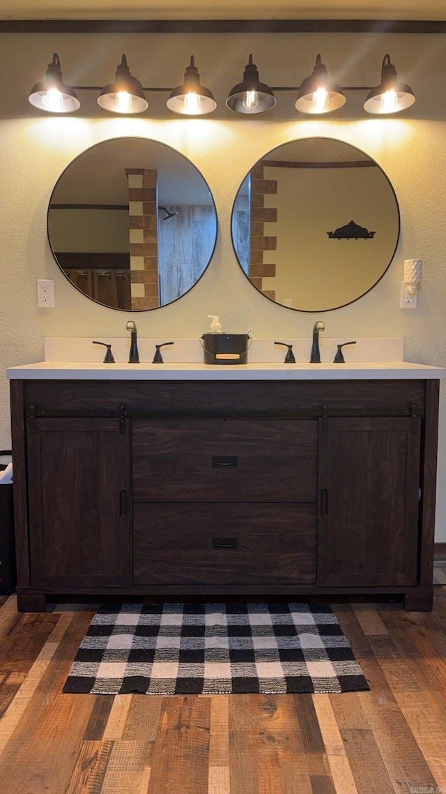 344 Rockwood Ln, Clinton, AR 72031 - bathroom featuring hardwood / wood-style floors, double vanity, and a sink