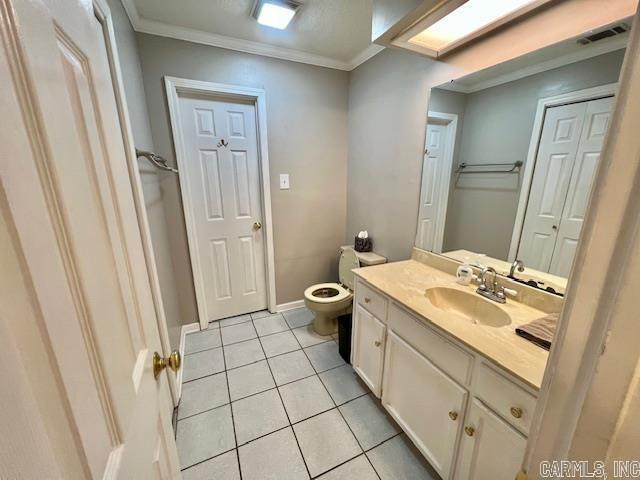 bathroom featuring visible vents, ornamental molding, toilet, vanity, and tile patterned flooring