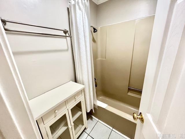 full bathroom with shower / bath combo with shower curtain and tile patterned floors