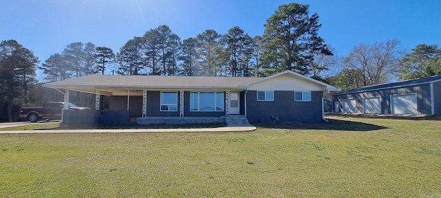 view of front of home featuring covered porch, brick siding, an outbuilding, and a front lawn