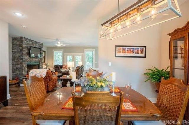 41 Rivers Edge Cv, Heber Springs, AR 72543 - dining room featuring a ceiling fan, a stone fireplace, and wood finished floors