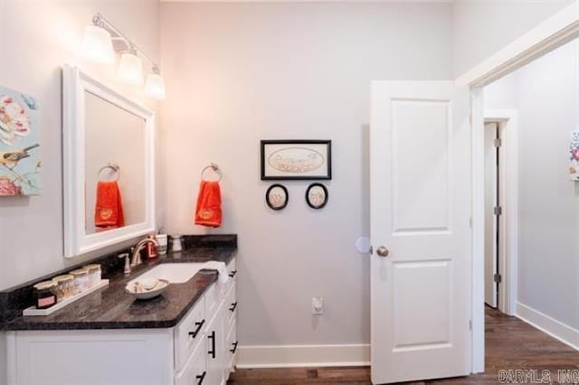 41 Rivers Edge Cv, Heber Springs, AR 72543 - bathroom with baseboards, wood finished floors, and vanity