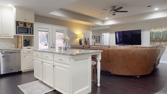6006 Shadyside, Texarkana, TX 75503 - kitchen featuring open floor plan, a tray ceiling, dark wood-style flooring, stainless steel appliances, and ceiling fan