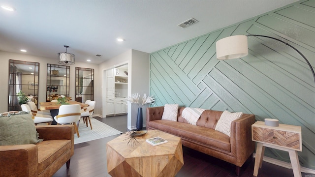 6006 Shadyside, Texarkana, TX 75503 - living area featuring dark wood finished floors, recessed lighting, an accent wall, and visible vents