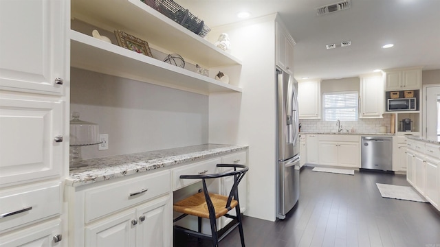 6006 Shadyside, Texarkana, TX 75503 - kitchen featuring a sink, open shelves, stainless steel appliances, visible vents, and decorative backsplash