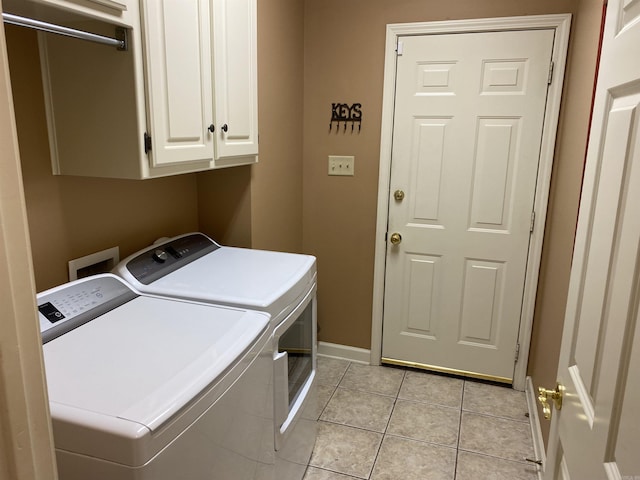 12706 Meadows Edge Ln, Little Rock, AR 72211 - clothes washing area with light tile patterned flooring, cabinet space, baseboards, and separate washer and dryer