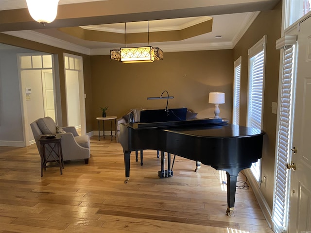 12706 Meadows Edge Ln, Little Rock, AR 72211 - living area with baseboards, a tray ceiling, crown molding, and light wood-type flooring
