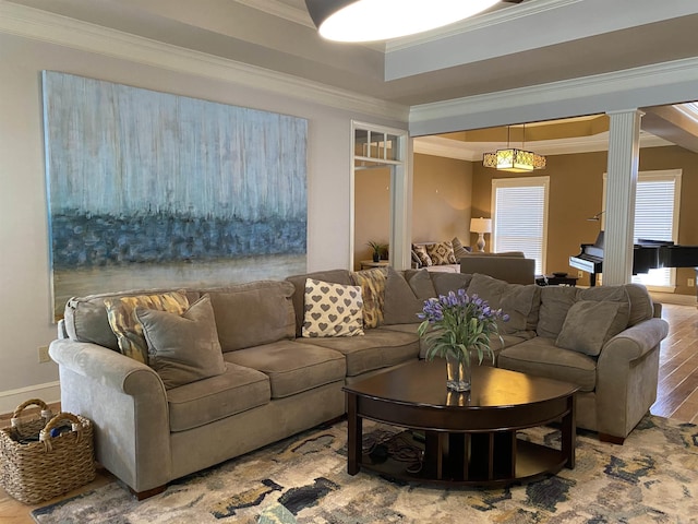 12706 Meadows Edge Ln, Little Rock, AR 72211 - living area featuring decorative columns, a raised ceiling, wood finished floors, baseboards, and ornamental molding