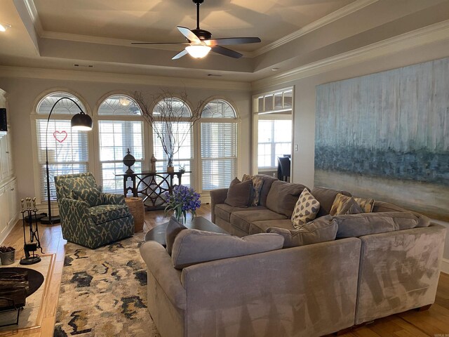 12706 Meadows Edge Ln, Little Rock, AR 72211 - living room with crown molding, wood finished floors, a ceiling fan, and a raised ceiling