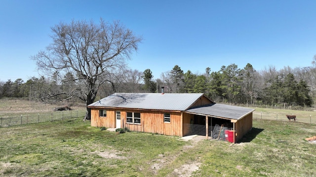 exterior space with an exterior structure, metal roof, and an outbuilding