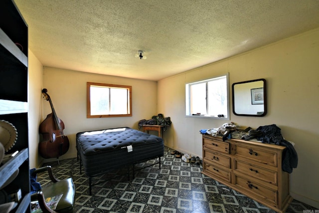 bedroom with multiple windows and a textured ceiling