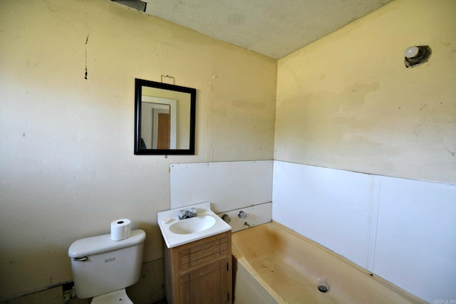 full bath with a tub, a textured ceiling, toilet, and vanity