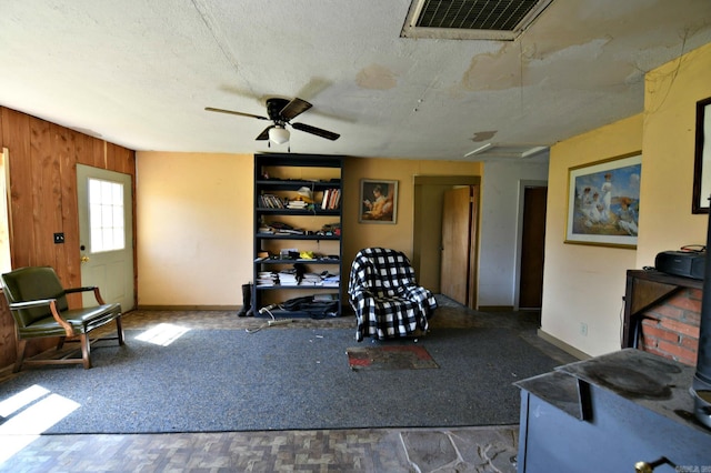sitting room featuring baseboards, visible vents, ceiling fan, and a textured ceiling