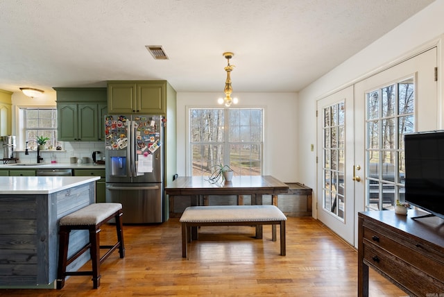 8 Allen Pt, Perryville, AR 72126 - kitchen featuring green cabinetry, light countertops, a sink, stainless steel appliances, and visible vents
