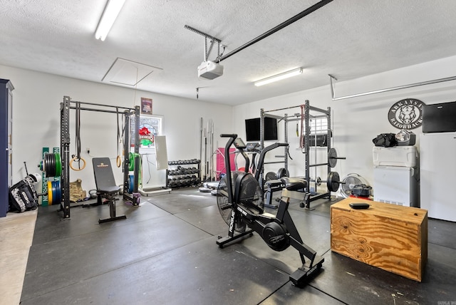 8 Allen Pt, Perryville, AR 72126 - workout area featuring a garage, a textured ceiling, and attic access