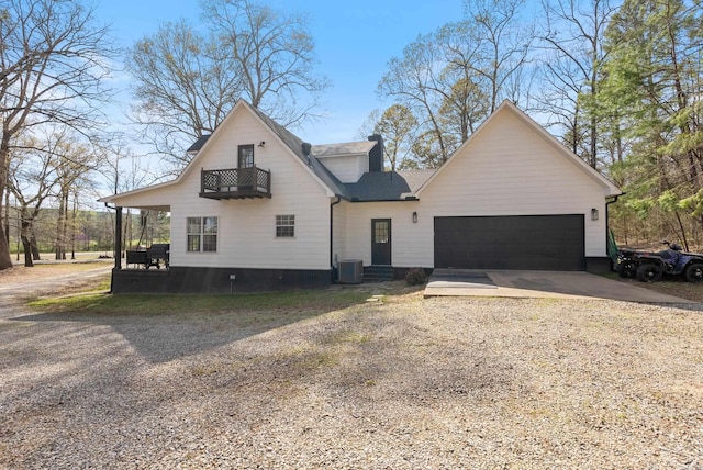 8 Allen Pt, Perryville, AR 72126 - view of front of house featuring a balcony, a garage, central AC unit, and concrete driveway