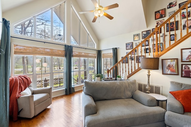 8 Allen Pt, Perryville, AR 72126 - living area with high vaulted ceiling, visible vents, wood finished floors, stairway, and a ceiling fan