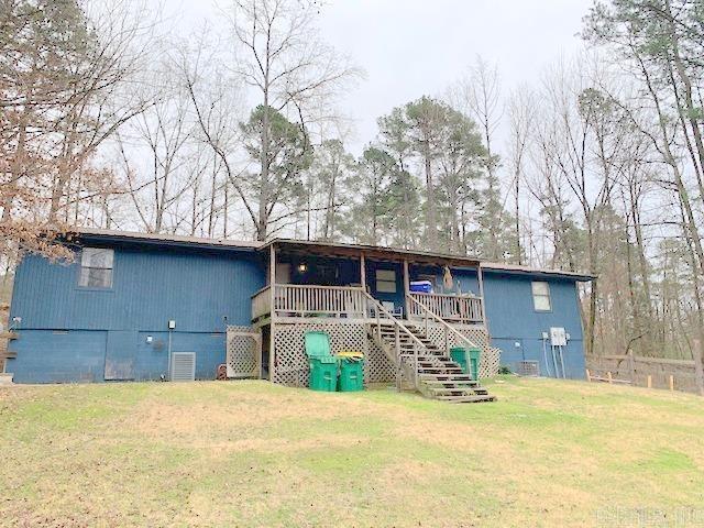 view of front of house with a front yard, crawl space, and stairway