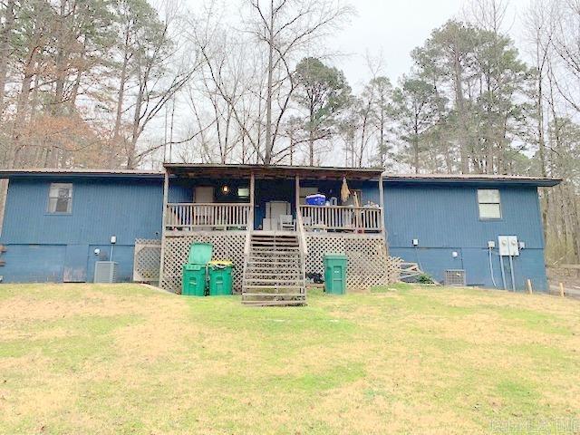 view of front of house with a front lawn, stairs, and crawl space