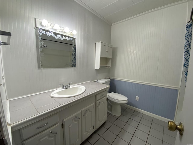 bathroom featuring toilet, tile patterned flooring, vanity, and crown molding