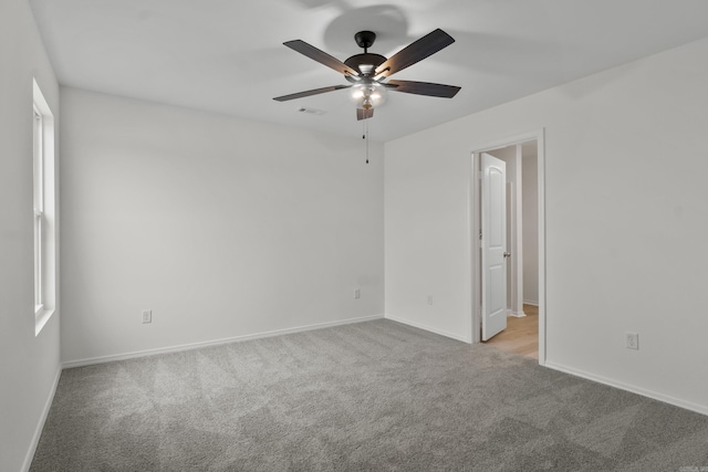 1233 Santa Fe Trl, Bauxite, AR 72011 - empty room featuring light colored carpet, baseboards, and a ceiling fan