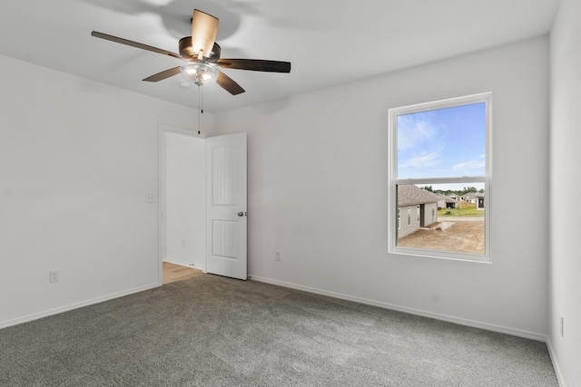 1233 Santa Fe Trl, Bauxite, AR 72011 - spare room with carpet floors, a ceiling fan, and baseboards