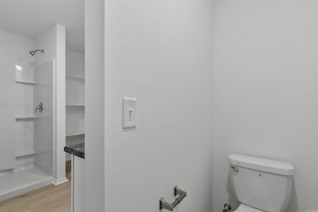1233 Santa Fe Trl, Bauxite, AR 72011 - bathroom featuring wood finished floors, a shower, toilet, and a textured wall