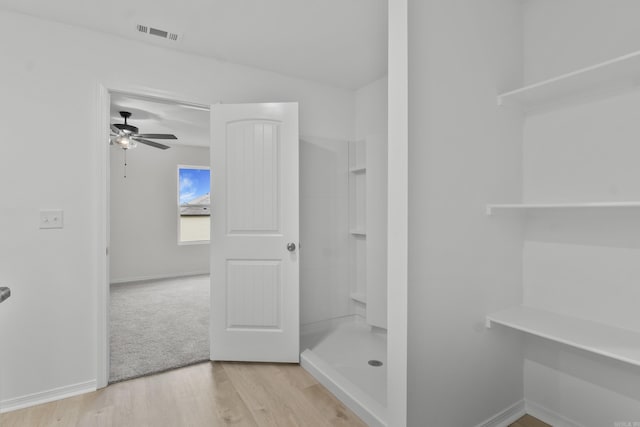 1233 Santa Fe Trl, Bauxite, AR 72011 - full bathroom featuring ceiling fan, a stall shower, wood finished floors, and baseboards