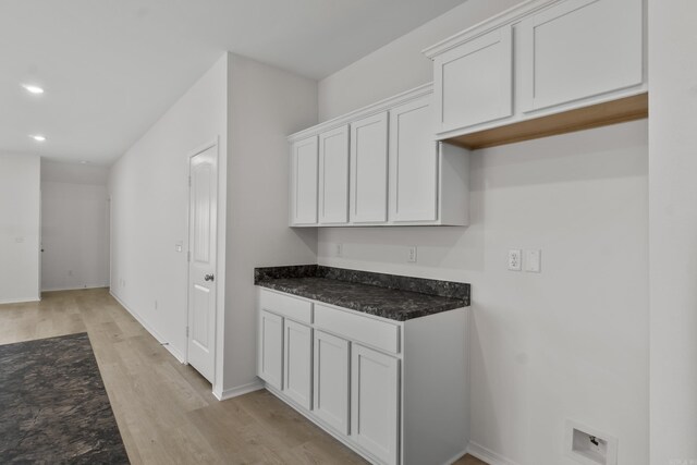 1233 Santa Fe Trl, Bauxite, AR 72011 - kitchen featuring light wood-type flooring, dark stone counters, white cabinets, recessed lighting, and baseboards