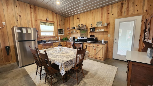 44 Duncan Ln, Story, AR 71970 - kitchen featuring open shelves, wooden walls, appliances with stainless steel finishes, under cabinet range hood, and dark countertops