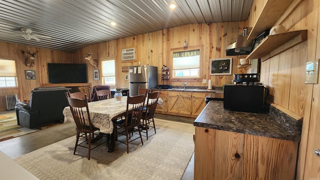 44 Duncan Ln, Story, AR 71970 - dining area with radiator, wooden walls, ceiling fan, and a wealth of natural light