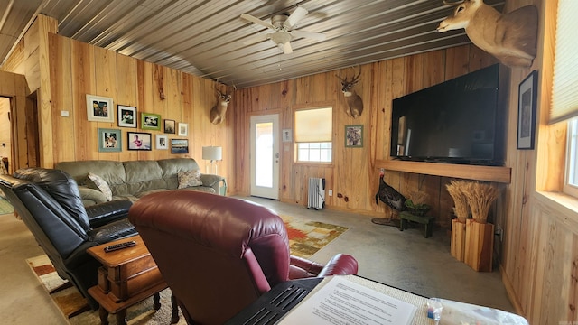 44 Duncan Ln, Story, AR 71970 - living room featuring wood walls, radiator heating unit, and a ceiling fan
