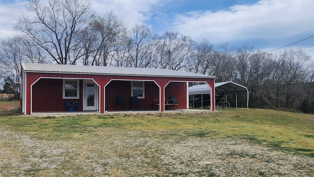44 Duncan Ln, Story, AR 71970 - view of front of property with metal roof, an outbuilding, board and batten siding, and a carport