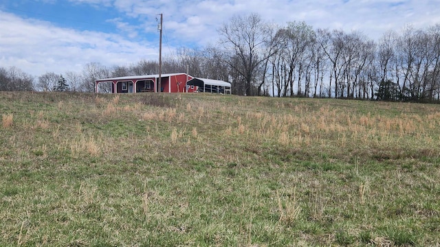 44 Duncan Ln, Story, AR 71970 - view of yard featuring a carport, an outbuilding, and an outdoor structure