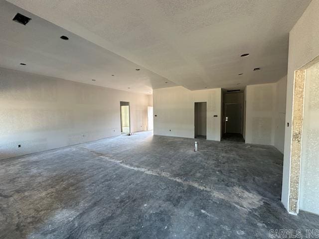 unfurnished room with a textured ceiling