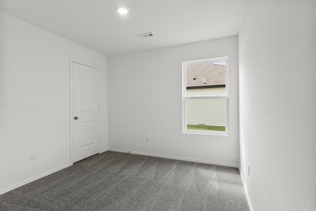 11089 River Valley Dr, Hensley, AR 72065 - unfurnished room featuring dark carpet and baseboards