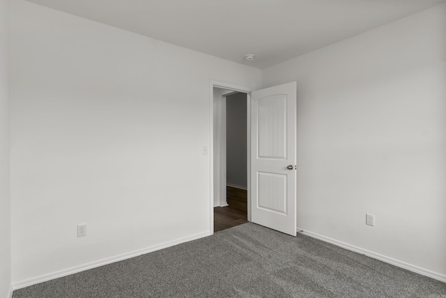 11089 River Valley Dr, Hensley, AR 72065 - unfurnished room with dark carpet and a smoke detector