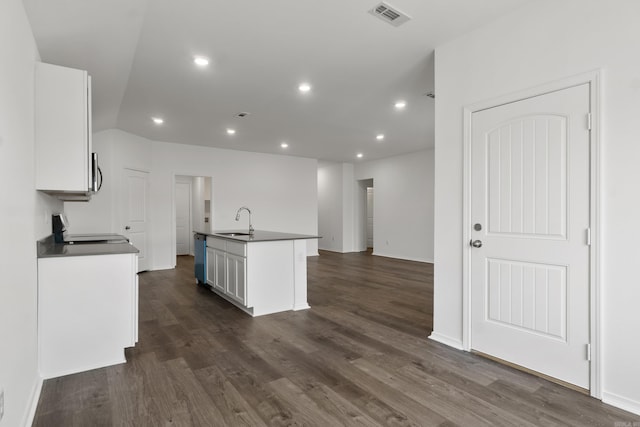 11089 River Valley Dr, Hensley, AR 72065 - kitchen featuring stove, dark countertops, white cabinets, stainless steel microwave, and dark wood-type flooring