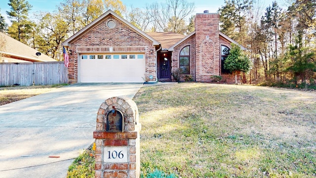 view of front of home featuring driveway, a chimney, fence, brick siding, and a garage