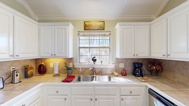 kitchen featuring crown molding, a sink, white cabinetry, dishwasher, and decorative backsplash
