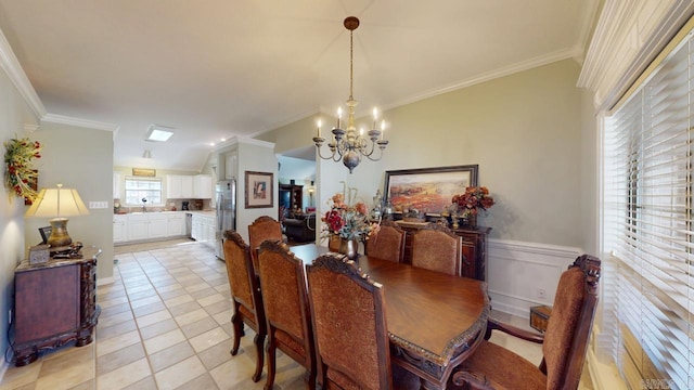 dining area featuring light tile patterned flooring, wainscoting, ornamental molding, and a chandelier